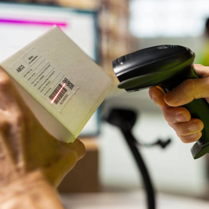 Person Scanning Label on Package